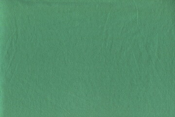 The texture of the soft knitted fabric is a pleasant turquoise color. Soft natural cotton, crumpled fabric.