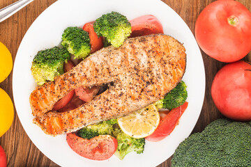 Grilled salmon with various vegetables on a plate