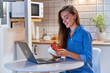 Joyful smiling happy beloved female receives a valentines day gift box online