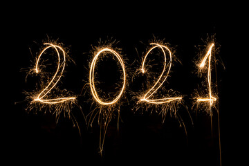 Obraz na płótnie Canvas Happy New Year 2021. Sparkling burning text Happy New Year 2021 isolated on black background.