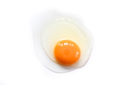 Raw eggs with yolk and white isolated on white background