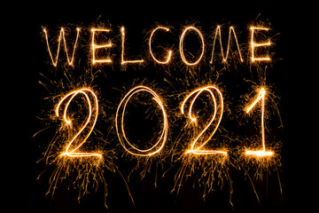 Happy New Year 2021. Sparkling burning text Happy New Year 2021 isolated on black background.