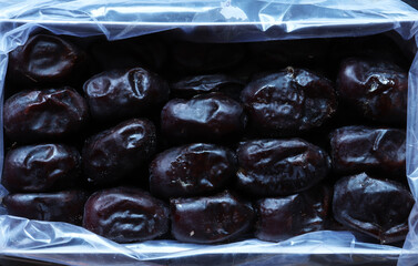 Photograph of a box of fresh organic mazafati dates for food background