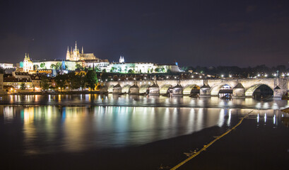 Pargue charles bridge and prague castle by night reflections river
