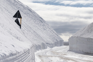 mountain snow covered road with signs
