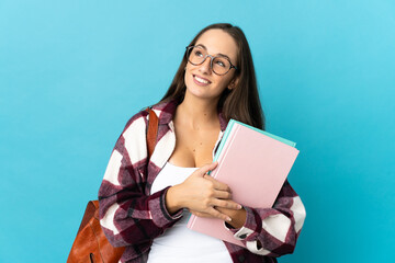 Young student woman over isolated background thinking an idea while looking up