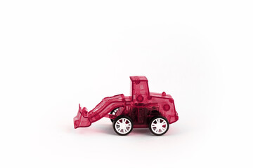 Colorful toy red plastic tractor isolated on white background. Red excavator. Toy for children.
  Side view. Copyspace for text. Poster for advertising.
