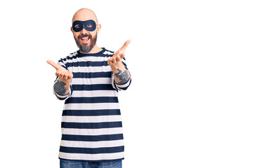 Young handsome man wearing burglar mask smiling cheerful offering hands giving assistance and acceptance.