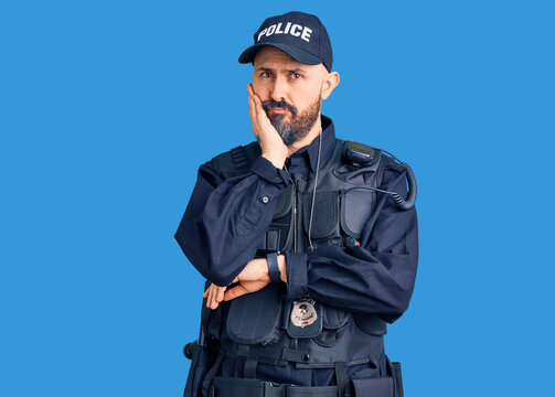 Young handsome man wearing police uniform thinking looking tired and bored with depression problems with crossed arms.