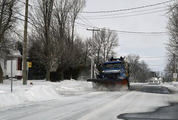 snowplow on a country road removing snow drifts from the road 