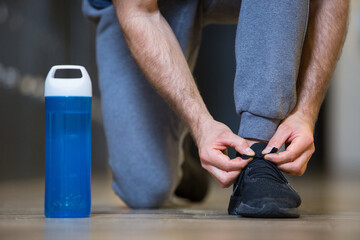 a sportsman tying his shoelace