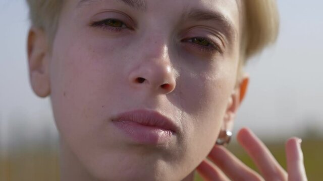 androgynous model portrait, close up of a blonde young lesbian woman