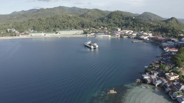 Local Passenger Fastcat Ferry Boat Preparing To Dock At The Liloan Port In Southern Leyte At Daytime In The Philippines. - Aerial Drone Approaching Shot