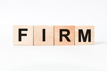 words FIRM on wooden cubes, white background. business concept