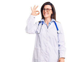 Young beautiful woman wearing doctor stethoscope and glasses smiling positive doing ok sign with hand and fingers. successful expression.