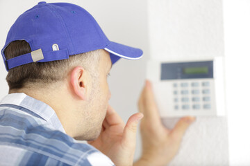 handsome young electrician repairing intercom © auremar