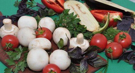 Fresh mushrooms and vegetables on a cutting board