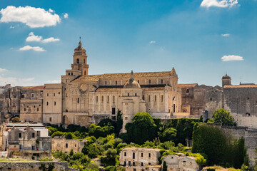Fototapeta premium Gravina in Puglia, Italy. The ancient cathedral of Santa Maria Assunta, with its bell tower, apse and dome.