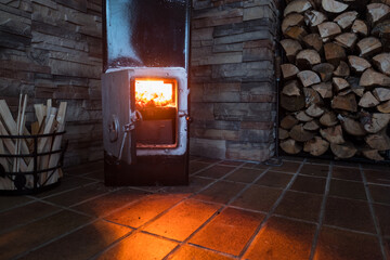 Fototapeta na wymiar fireplace with wood and stone decorative wall, cottage equipment