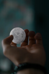 hand holding the moon