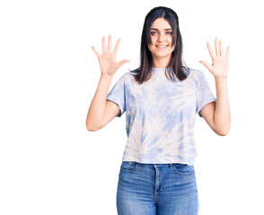 Young beautiful girl wearing casual t shirt showing and pointing up with fingers number ten while smiling confident and happy.