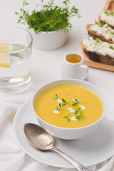 zucchini soup and  sandwich on a board near by sause