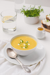 zucchini soup and  sandwich on a board near by sause