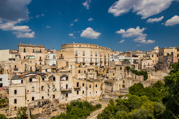 Fototapeta premium Gravina in Puglia, Italy. The skyline of the city with its ancient houses and buildings. Some broken walls and remains of collapsed and ruined houses.
