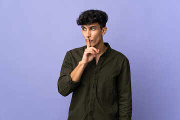 Young Argentinian man isolated on background showing a sign of silence gesture putting finger in...