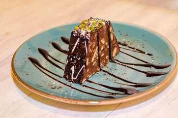 Chocolate mosaic cake on blue porcelain plate