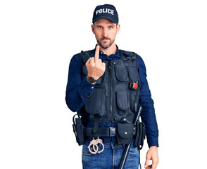 Young handsome man wearing police uniform showing middle finger, impolite and rude fuck off expression