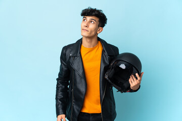 Argentinian man with a motorcycle helmet and looking up