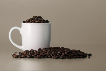 Blank white cup full of coffee beans. White mockup