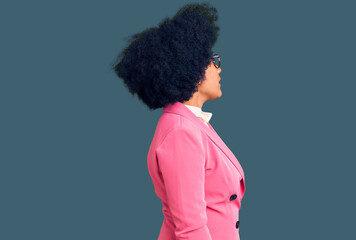 Fototapeta na wymiar Young african american girl wearing business clothes and glasses looking to side, relax profile pose with natural face with confident smile.