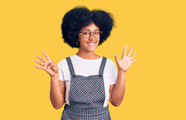Young african american girl wearing casual clothes showing and pointing up with fingers number nine while smiling confident and happy.