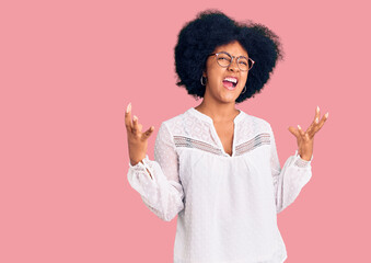 Young african american girl wearing casual clothes crazy and mad shouting and yelling with aggressive expression and arms raised. frustration concept.