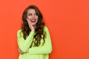 Laughing Young Woman In Neon Lime Green Sweater Is Looking Away