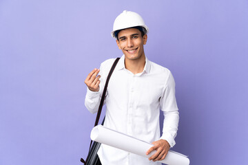 Young architect man isolated on background making money gesture