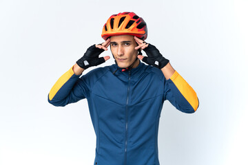 Young cyclist man isolated on background having doubts and thinking