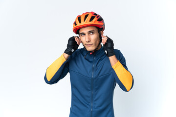 Young cyclist man isolated on background frustrated and covering ears