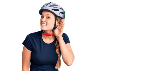 Beautiful caucasian woman wearing bike helmet smiling with hand over ear listening an hearing to rumor or gossip. deafness concept.