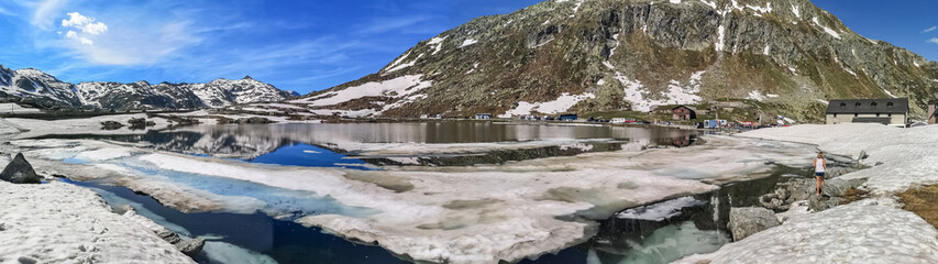 Ultra wide panorama of the frozen lake in the Gotthardpass