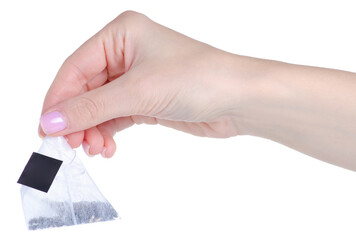 Close-up of tea bag in hand on white background isolation