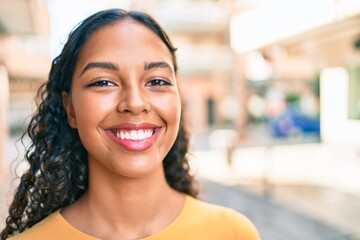 Young african american girl smiling happy walking at city.