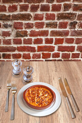 White plate gratin of macaroni in ceramic bow