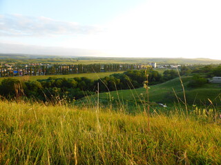 Fototapeta premium Grass, valley, horizon. View of the city of Kislovodsk