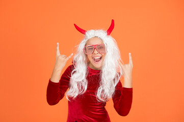 happy devil kid with party glasses and white hair wear horns costume of imp on halloween party,...