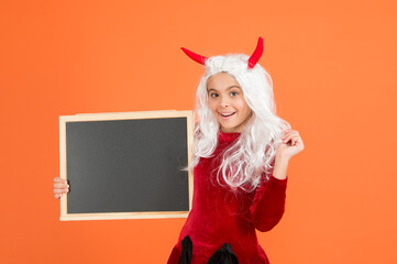 halloween devil kid in imp horns hold school chalkboard for copy space, happy halloween
