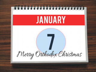 Fototapeta premium Calendar, January 7th, Merry Orthodox Christmas, on wooden background, illustration