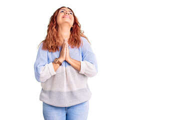 Young latin woman wearing casual clothes begging and praying with hands together with hope expression on face very emotional and worried. begging.